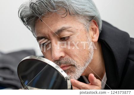 Mature men looking at mirrors Mature men looking at mirrors 124373877