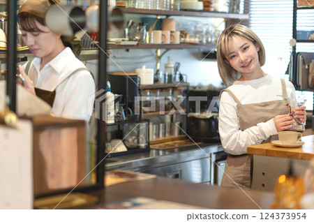 A cafe attendant preparing to make coffee 124373954