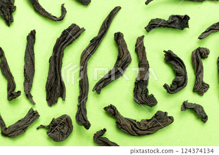 Large leaf black tea rolled leaves of different shapes, top view macro Large leaf black tea rolled leaves of different shapes, top view macro 124374134