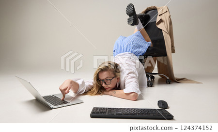 Creative office worker in surreal pose against white studio background, representing challenge of staying productive under stress. 124374152