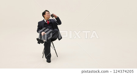 Poster. Businessman, Asian man sitting on chair with coffee having rest against white background with negative space. 124374205