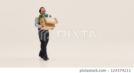 Overjoyed young Asian man, carrying huge cardboard box with clothes, and quitting job against white background with negative space. Ad Overjoyed young Asian man, carrying huge cardboard box with clothes, and quitting job against white background with negative space. Ad 124374211