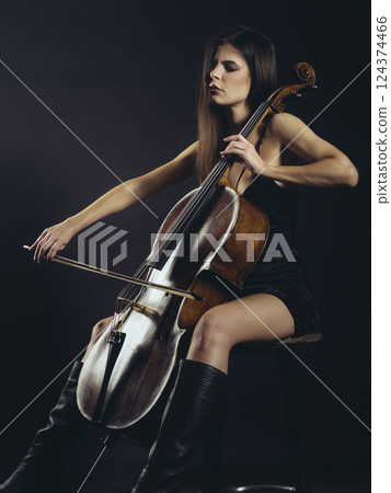 Attractive cello player playing her instrument 124374466