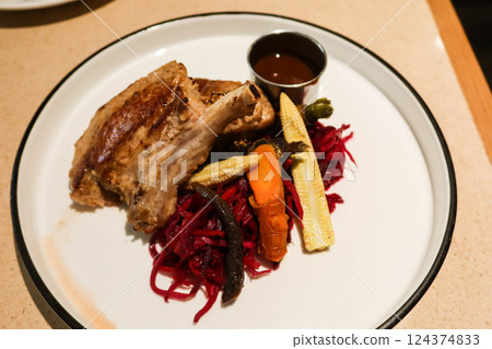close up of grilled lamb meat mutton drumstick rack on a green plate with copy space 124374833