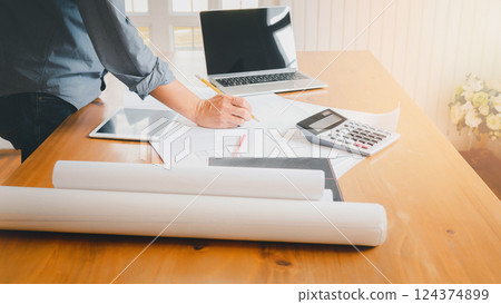 An architect or engineer writing on blueprint, architectural concept. 124374899
