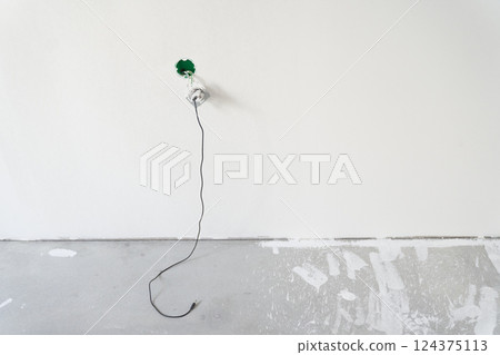 Electrical outlet, phone charger on the background of a white wall. The concept of technology. With space to copy. High quality photo Electrical outlet, phone charger on the background of a white wall. The concept of technology. With space to copy. High quality photo 124375113