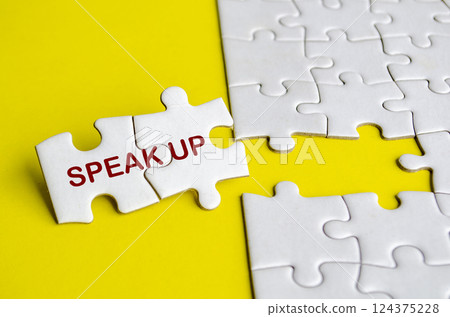 Speak Up text on missing jigsaw puzzle. Courage to speak up concept Speak Up text on missing jigsaw puzzle. Courage to speak up concept 124375228