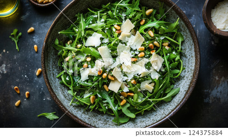 Arugula Salad with Parmesan and Pine Nuts in Rustic Bowl Arugula Salad with Parmesan and Pine Nuts in Rustic Bowl 124375884