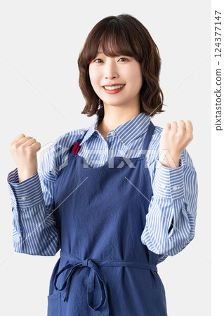 A woman in an apron with a guts pose A woman in an apron with a guts pose 124377147