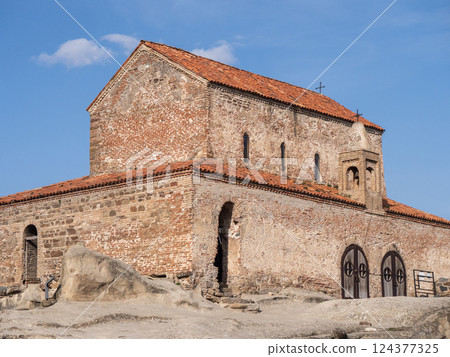 Ancient christian church building in a serene landscape setting Ancient christian church building in a serene landscape setting 124377325