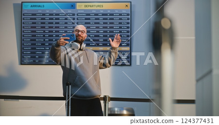 Crowded International Airport Terminal: Popular Travel Blogger Filming Video Content 124377431