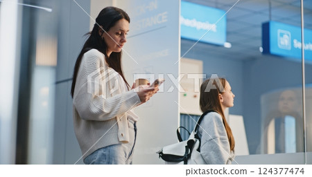 Crowded Airport Terminal: Naughty Daughter Talking and Arguing with Mother 124377474