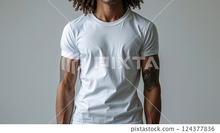 Man wearing white t shirt showing tattoos on arms 124377836
