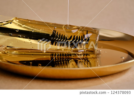 Bottle with brush filled with oil for eyebrow and eyelash growth. Texture. Bottle with brush filled with oil for eyebrow and eyelash growth. Texture. 124378093