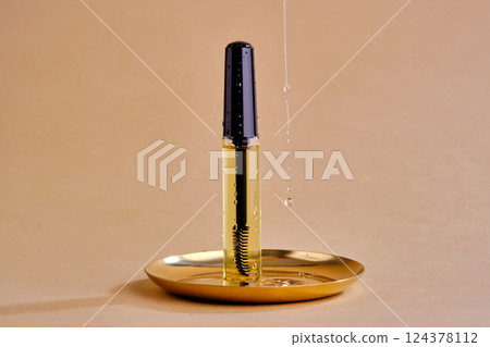 Bottle with brush filled with oil for eyebrow and eyelash growth. Texture. 124378112