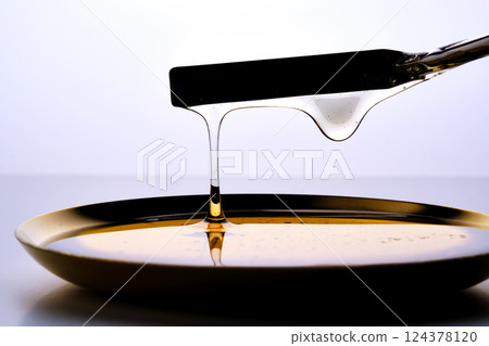 Photo of a sugar paste for depilation hair removal procedure. Texture. 124378120
