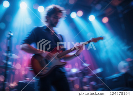 Musician playing electric guitar on stage in a nightclub, blurred image 124378194