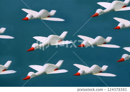 flock of white geese in flight flock of white geese in flight 124378381