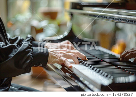Close up of pianist playing keyboard, showcasing musical talent 124378527