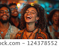 a woman is laughing in front of a crowd of people 124378552