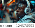 A youth with headphones is enjoying music artist at an event 124378553