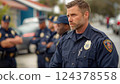 A male police officer looks through the lens at the background of his fellow officers 124378558