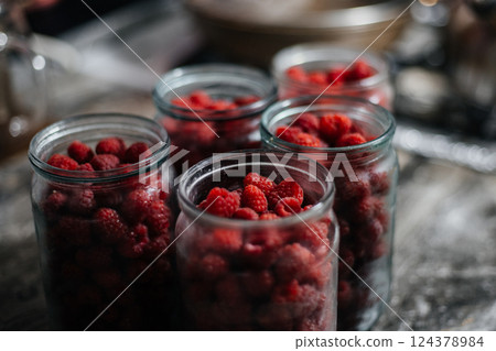 Raspberries in a glass jar. Preparation for making jam or compote. Home canning Raspberries in a glass jar. Preparation for making jam or compote. Home canning 124378984
