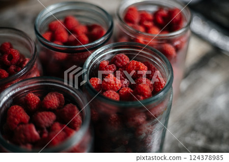 Raspberries in a glass jar. Preparation for making jam or compote. Home canning 124378985