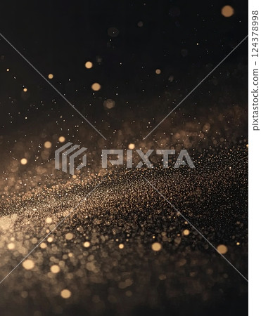 Golden dust particles floating in the air against a dark background 124378998