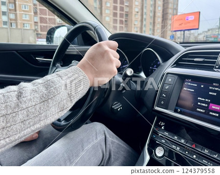a man driving his personal car goes to the city on business a man driving his personal car goes to the city on business 124379558