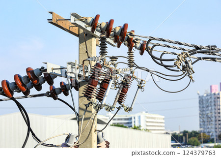 porcelain insulator on High voltage post, High voltage tower, show with high voltage construction and power lines. 124379763