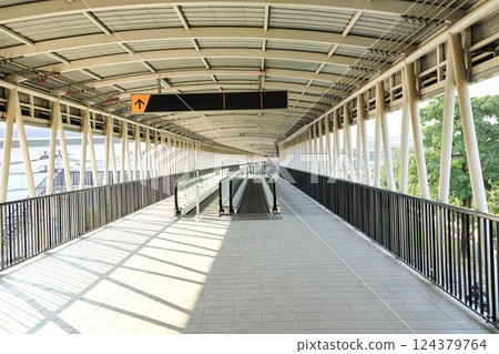 Pedestrian pathway or corridor or hallway between train station and other building. 124379764
