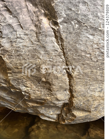 Textured rock surface with natural patterns showcasing geological features and formations nature concept 124379809