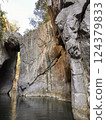 Majestic rock formations towering over tranquil water in a serene canyon landscape natural beauty concept 124379833