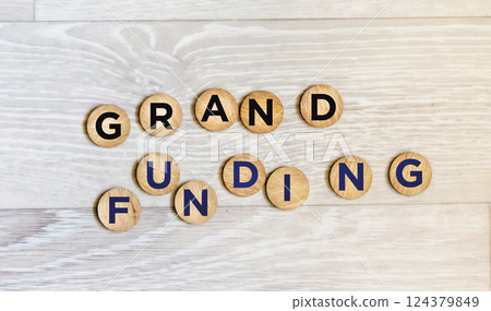 The symbol of grant financing. The conceptual words are Grant financing on wooden coins.  124379849