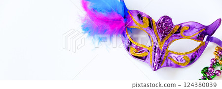 Carnival mask with feathers and colorful beads on white background. Mardi Gras or Fat Tuesday symbol. Festive decorations for traditional holiday. Copy space, banner format. Carnival mask with feathers and colorful beads on white background. Mardi Gras or Fat Tuesday symbol. Festive decorations for traditional holiday. Copy space, banner format. 124380039
