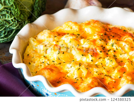 Cauliflower casserole with cheese and milk sauce in a baking dish Cauliflower casserole with cheese and milk sauce in a baking dish 124380325
