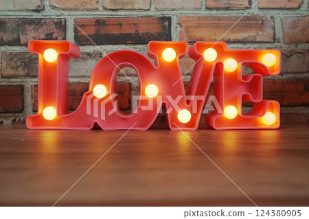 Love LED sign for Valentine's day on wooden background Love LED sign for Valentine's day on wooden background 124380905