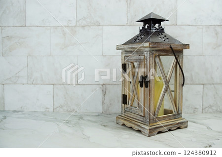Wooden lantern on marble background 124380912