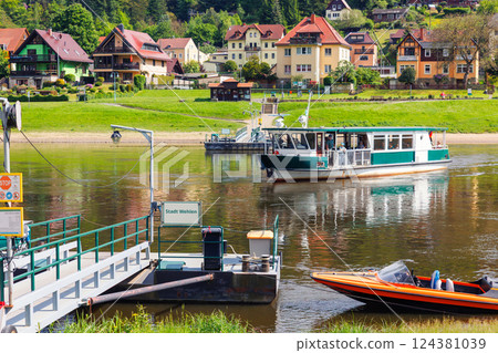 Scenic view old ferry boat cruising Elbe river Whelen Sachsische Schweiz National Park Germany mountain valley on summer sunny day. Europe travel nature landscape destination Scenic view old ferry boat cruising Elbe river Whelen Sachsische Schweiz National Park Germany mountain valley on summer sunny day. Europe travel nature landscape destination 124381039