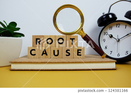 Magnifying glass and alarm clock with wooden blocks alphabet letters ROOT CAUSE text message on yellow background Magnifying glass and alarm clock with wooden blocks alphabet letters ROOT CAUSE text message on yellow background 124381166