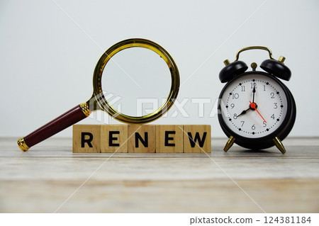Time to Renew with wooden blocks alphabet letters and Magnifying glass on wooden background Time to Renew with wooden blocks alphabet letters and Magnifying glass on wooden background 124381184