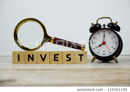 Time to Invest with wooden blocks alphabet letters and Magnifying glass on wooden background Time to Invest with wooden blocks alphabet letters and Magnifying glass on wooden background 124381189