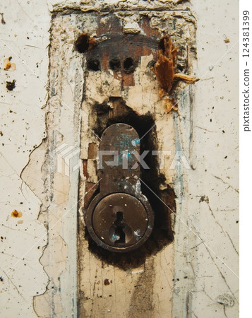 Close-Up of Old Rusty Keyhole on Damaged Door Close-Up of Old Rusty Keyhole on Damaged Door 124381399