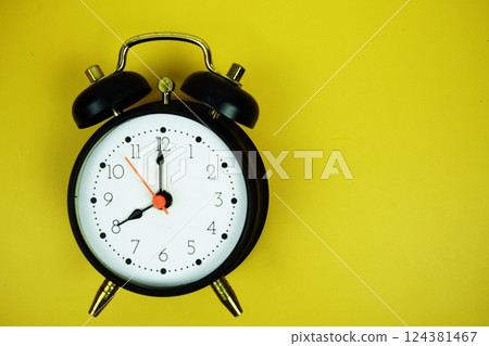 Alarm clock with space for text top view on yellow background Alarm clock with space for text top view on yellow background 124381467