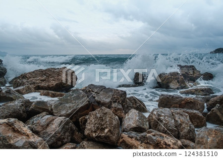 Waves Crashing Against Rocky Shoreline  124381510