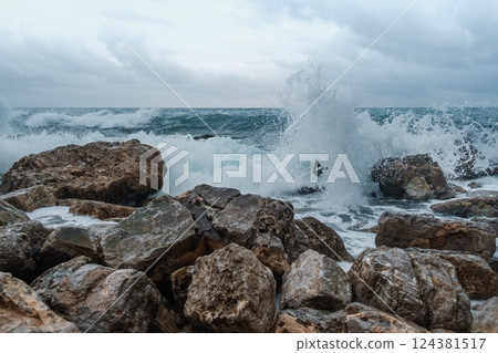 Waves Crashing Against Rocky Shoreline  124381517