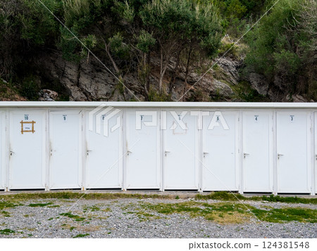 Row of White Public Toilets in Nature Row of White Public Toilets in Nature 124381548