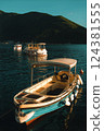 Boats Moored on Serene Waters at Sunset in Mediterranean bay of Kotor fjord 124381555
