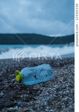 Plastic Bottle and Waste Polluting a Beach  124381556